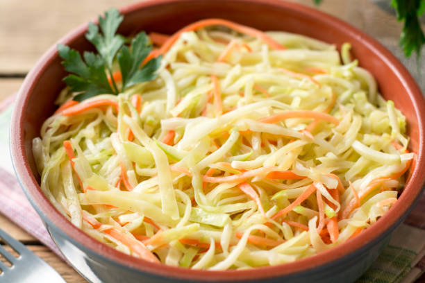 istock Fresh coleslaw salad in bowl on rustic wooden table 931510186