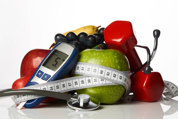 stethoscope glucometer fruits and dumbbells, diabetes concept - diabetes superfoods imagens e fotografias de stock