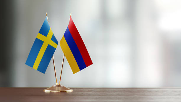 istock Swedish And Armenian Flag Pair On A Desk Over Defocused Background 931523916