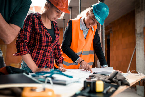 istock A group of people is reviewing plans for construction work 931524006