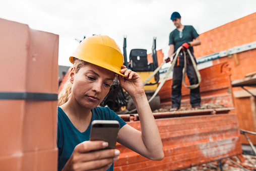A Young Construction Worker Writes A Text Message During A Break At A ...
