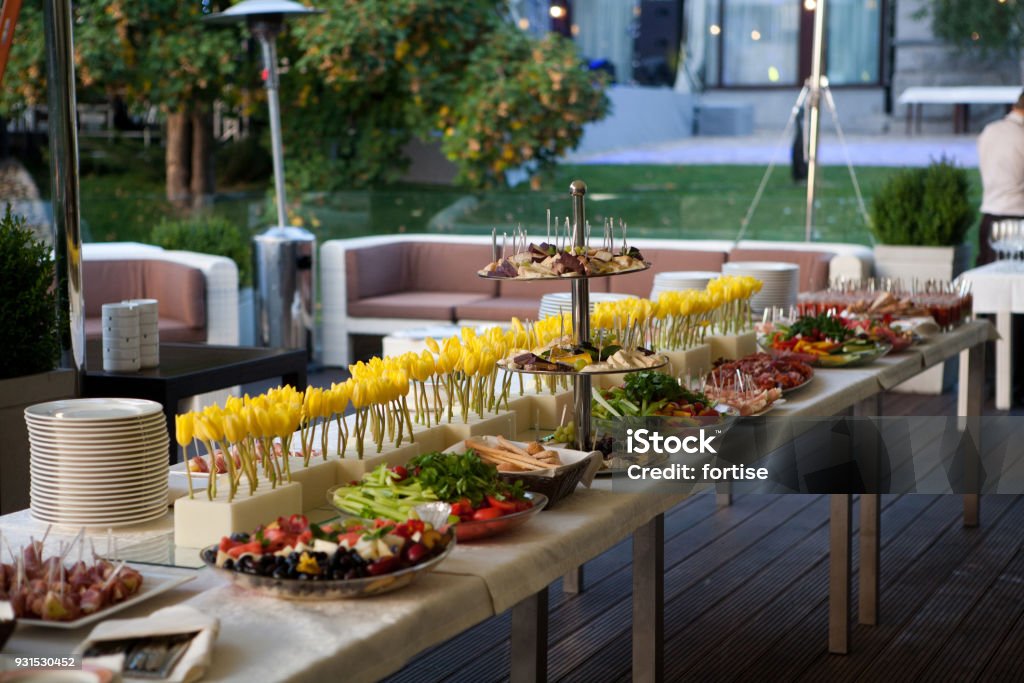 Buffet line of lunch and dinner.Buffet self-service food Buffet served table with snacks,fruits,canape,sweets and appetizers.Catering event plate service.Smorgasbord,food choice of breakfast in restaurant Food And Drink Industry Stock Photo