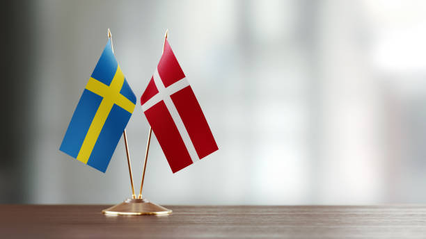 istock Swedish And Danish Flag Pair On A Desk Over Defocused Background 931530608