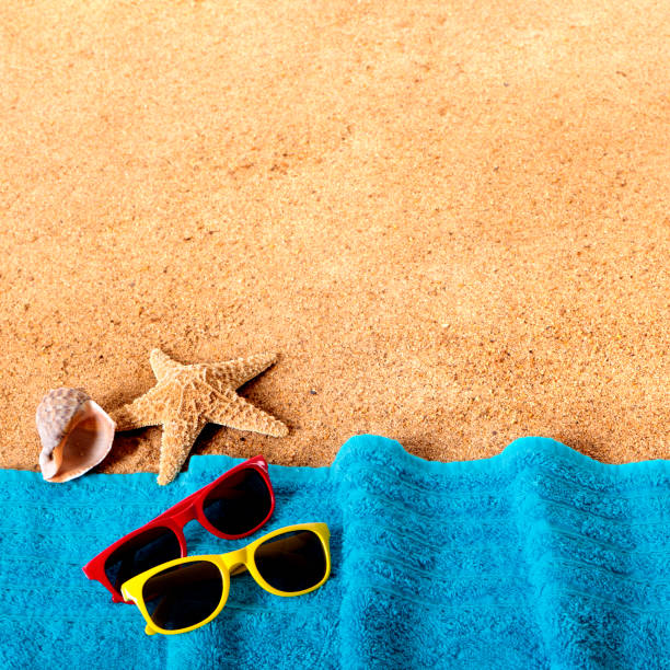 istock Beach background border with sunglasses, towel, starfish and seashells square format 931530760