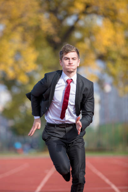 istock Young businessman in suit running on track 931530882