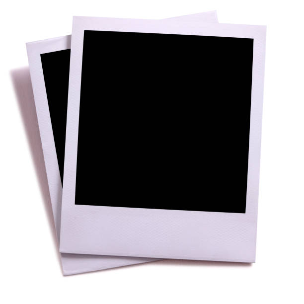 istock Two blank instant camera photo prints isolated on white with shadow. 931530932