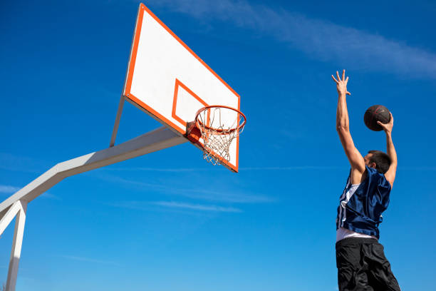 istock Young Basketball street player making slam dunk 931531242