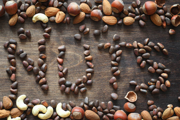 istock Different nuts on a wooden table. Cedar, cashew, hazelnut, walnu 931531340