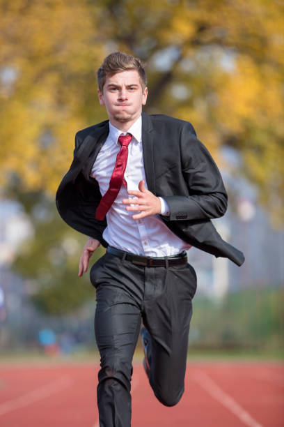 istock Young businessman in suit running on track 931531430