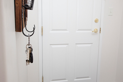 entryway of a home with front door, keys and shelf