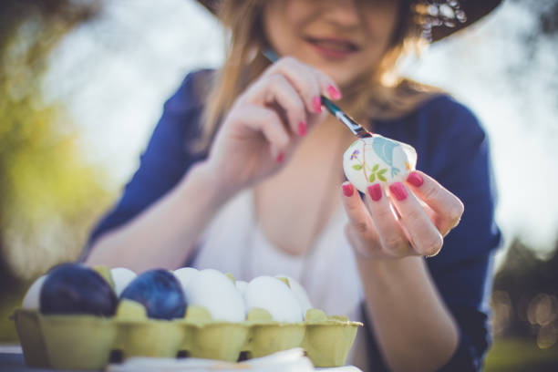 istock Close-up of a woman decorating Easter eggs with decoupage technique 931537476