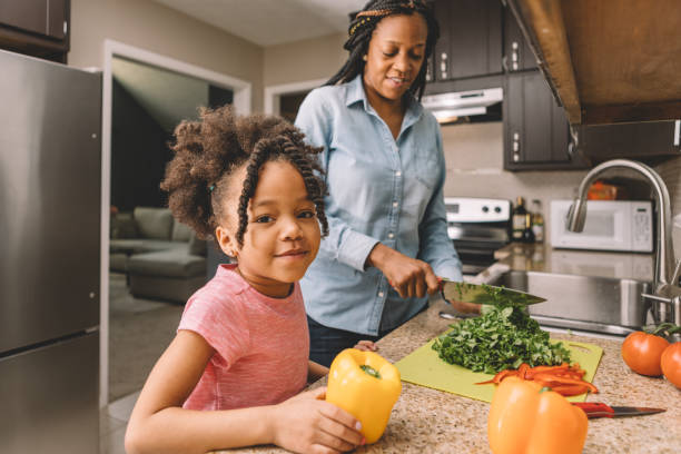 istock mother and daughter making a salad 931543234