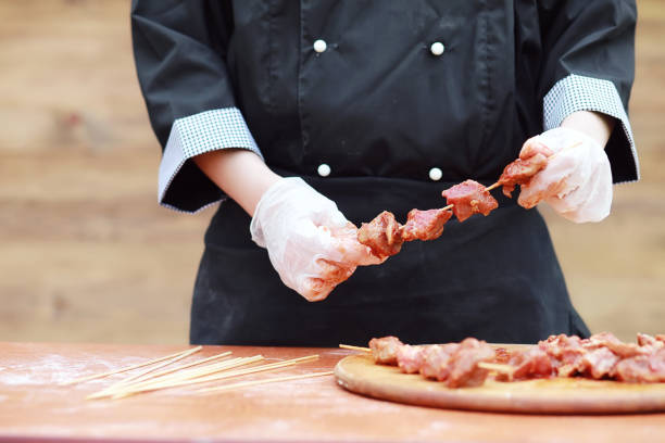 istock The cook cuts meat for cooking barbecue 931543404