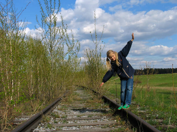 istock Girl  balancing on rail 93154378