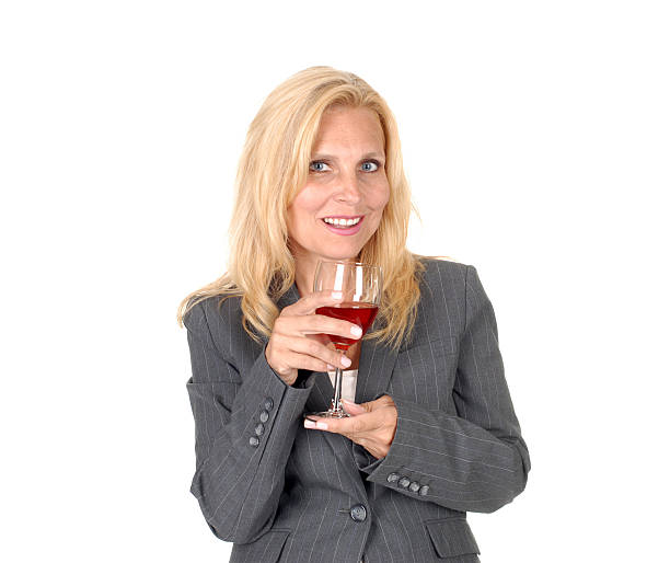 Group of senior, retirement, elderly friends women enjoy leisurely travel drinking wine, engaged with smartphone technology or tablets carefree holiday, happy stay connected digital social lifestyle