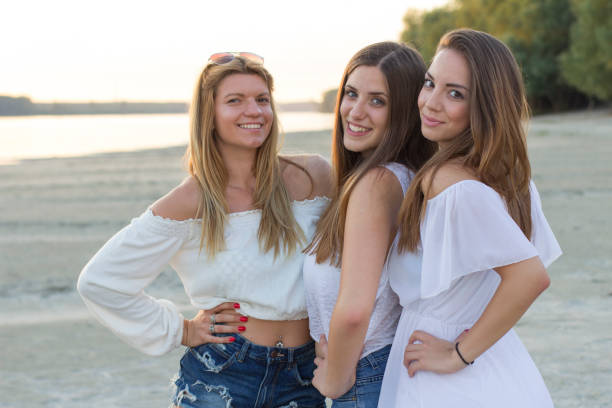 istock Three beautiful girls on the sandy beach 931547128