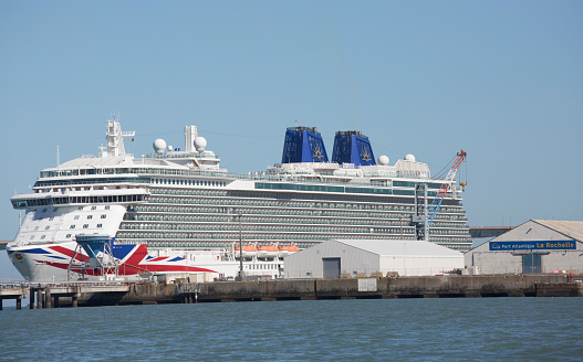 La rochelle, France - August 22, 2016 : Front view of Cruise ship, the Britannia by P & O Cruises anchored at the port of La rochelle, France. We can see cranes that are loading equipment and food.