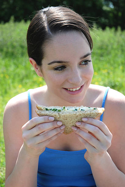 istock Pretty girl eating sandwich 93155430