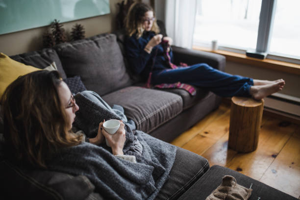 istock Two young woman relaxing on the sofa 931557990