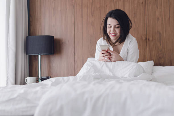 istock Relaxed woman at home reading a text message 931558558