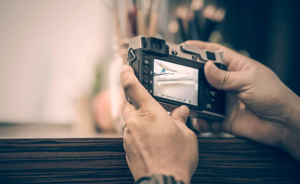 istock man holding vintage camera taking a photo 931559856
