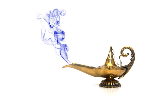 Brass genie lamp emitting blue smoke against white backdrop A magical genie lamp with smoke. magic lamp photos stock pictures, royalty-free photos & images
