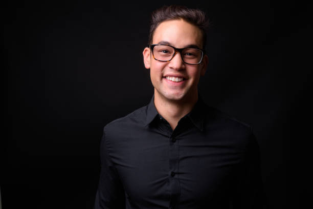 istock Young handsome multi-ethnic businessman against black background 931560392