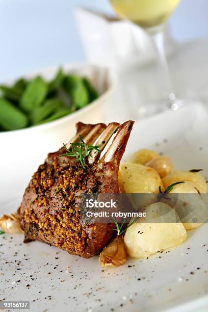 Seasoned Rack Of Lamb Served With A Side Dish Stock Photo - Download Image Now - Rack of Lamb, Lamb Chop, Dinner