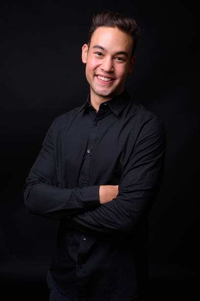 istock Young handsome multi-ethnic businessman against black background 931562314