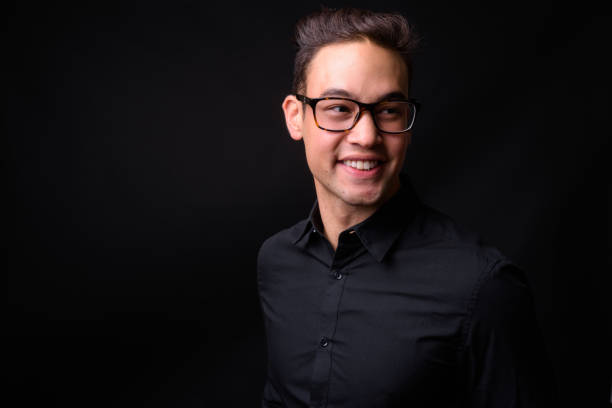 istock Young handsome multi-ethnic businessman against black background 931562426