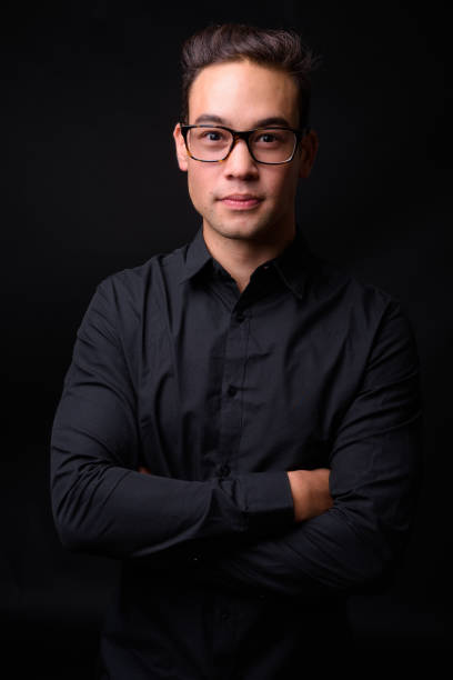 istock Young handsome multi-ethnic businessman against black background 931562428