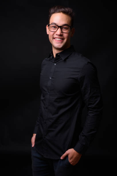 istock Young handsome multi-ethnic businessman against black background 931562434