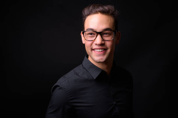 istock Young handsome multi-ethnic businessman against black background 931562444