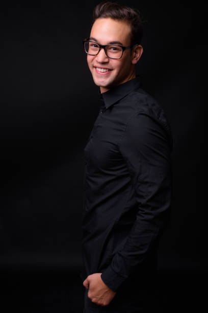 istock Young handsome multi-ethnic businessman against black background 931562454