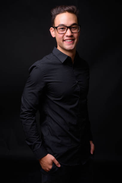 istock Young handsome multi-ethnic businessman against black background 931562458
