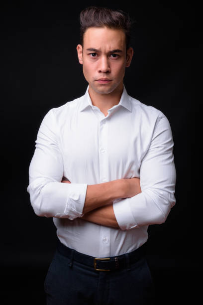 istock Young handsome multi-ethnic businessman against black background 931562712