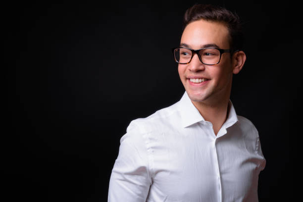 istock Young handsome multi-ethnic businessman against black background 931563016