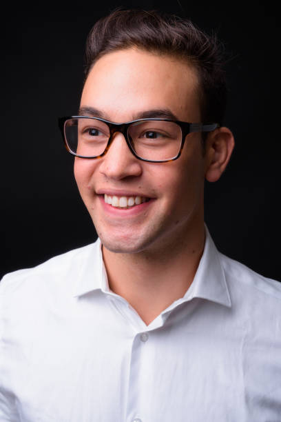istock Young handsome multi-ethnic businessman against black background 931563054