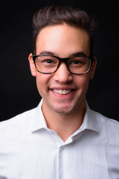 istock Young handsome multi-ethnic businessman against black background 931563084