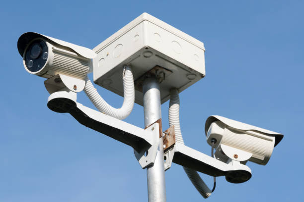 istock Outdoor CCTV Camera Operating for security in garden , on blue sky background 931567086