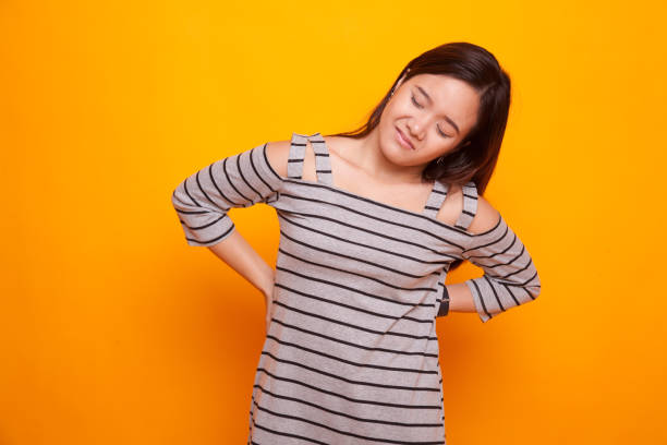 istock Young Asian woman got back pain. 931574042