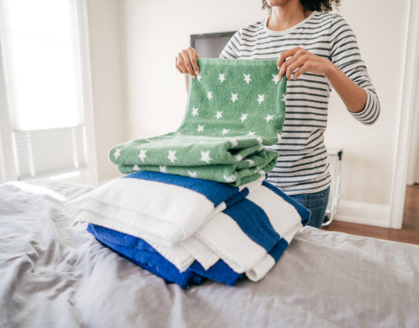 istock Woman folding towels 931575288
