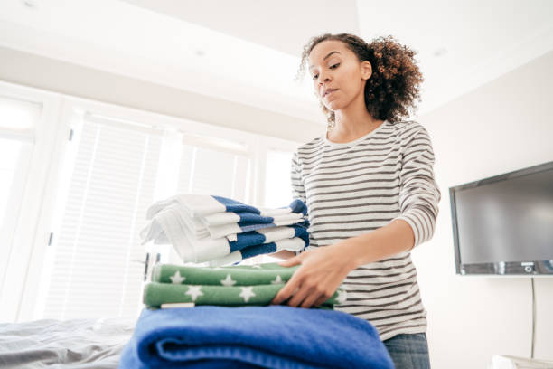 istock Woman folding towels 931575296