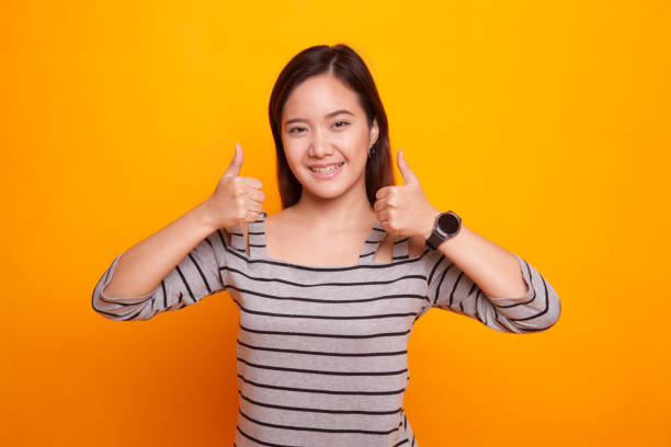 istock Young Asian woman show two thumbs up. 931578020