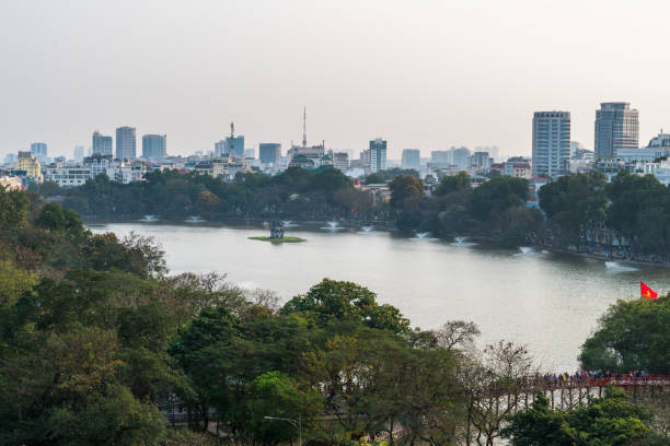Aerial skyline view of Hoan Kiem lake or Ho Guom, Sword lake. Hoan Kiem is center of Hanoi city. Hanoi cityscape. Aerial skyline view of Hoan Kiem lake or Ho Guom, Sword lake area at twilight. Hoan Kiem is center of Hanoi city. Hanoi cityscape. ho guom stock pictures, royalty-free photos & images