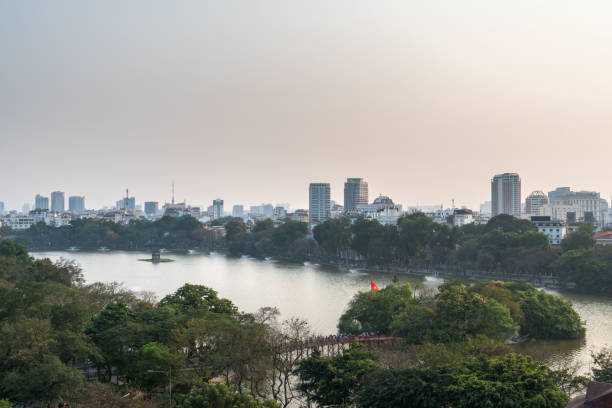 Aerial skyline view of Hoan Kiem lake or Ho Guom, Sword lake. Hoan Kiem is center of Hanoi city. Hanoi cityscape. Aerial skyline view of Hoan Kiem lake or Ho Guom, Sword lake area at twilight. Hoan Kiem is center of Hanoi city. Hanoi cityscape. ho guom stock pictures, royalty-free photos & images