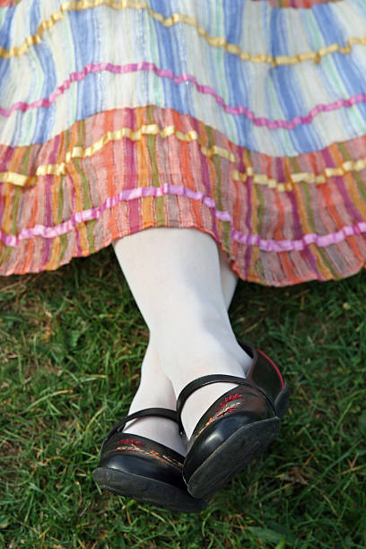 istock Feet and skirt resting on the grass 93158230