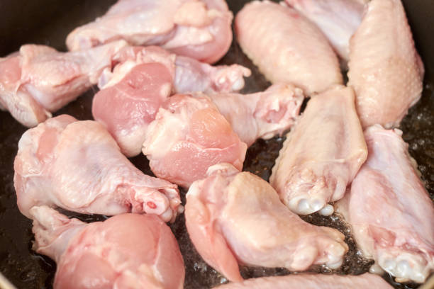 istock chicken wings frying with oil on a hot pan 931582608