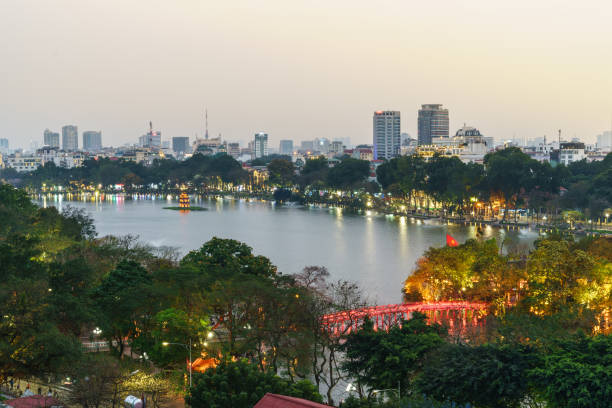 Aerial skyline view of Hoan Kiem lake or Ho Guom, Sword lake. Hoan Kiem is center of Hanoi city. Hanoi cityscape. Aerial skyline view of Hoan Kiem lake or Ho Guom, Sword lake area at twilight. Hoan Kiem is center of Hanoi city. Hanoi cityscape. ho guom stock pictures, royalty-free photos & images