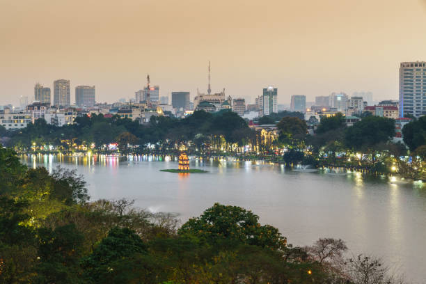 Aerial skyline view of Hoan Kiem lake or Ho Guom, Sword lake. Hoan Kiem is center of Hanoi city. Hanoi cityscape. Aerial skyline view of Hoan Kiem lake or Ho Guom, Sword lake area at twilight. Hoan Kiem is center of Hanoi city. Hanoi cityscape. ho guom stock pictures, royalty-free photos & images